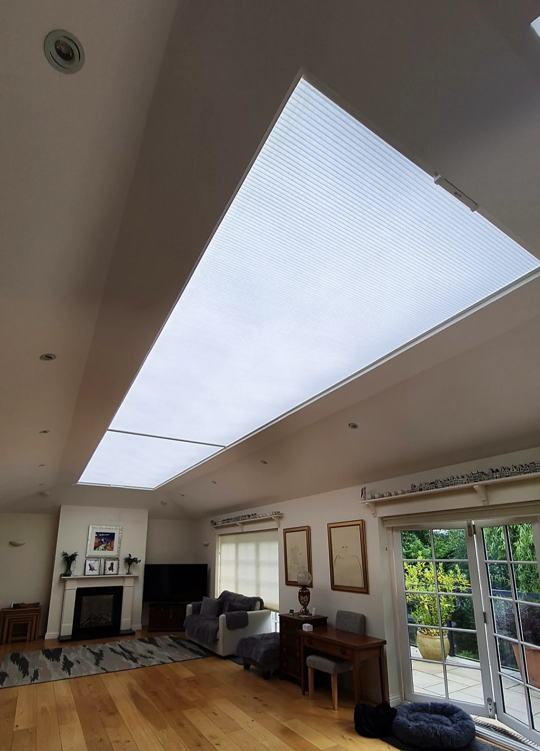 Cellular roof lantern blind closed over a living room, softening the daylight